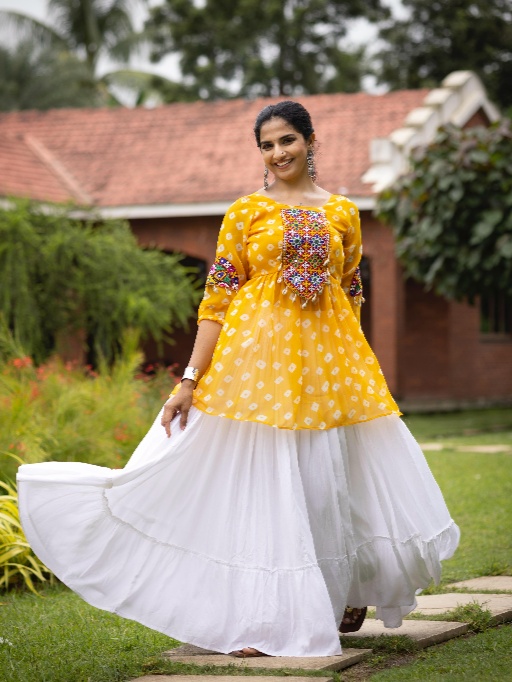 Women Lehenga With Kediya Top for Navratri Celebrate the joy of Navratri with our vibrant and traditional Women’s Lehenga with Kediya Top, specially designed for Garba and Dandiya nights. This colorful ethnic ensemble, featuring bold and festive shades like Rani, Purple, Green, and Yellow, is a true reflection of the season’s spirit and cultural heritage. At EthnicSuits.in, we bring you trendy yet traditional Navratri outfits that combine comfort with eye-catching design. This lehenga with kediya top is a must-have addition to your festive wardrobe! Colorful and Captivating Design This festive Navratri set includes: Lehenga (Skirt): Flowy and flared, designed with multi-color panels in shades of rani pink, purple, green, and yellow, creating a lively and playful look. Accented with traditional prints, embroidery, or mirror work (if applicable), it moves beautifully with every twirl. Kediya Top (Short Frock Style Top): Featuring a peplum-style flare with embroidered detailing or mirror accents, designed in a coordinating color palette. The Kediya top is inspired by Gujarati folk fashion, adding an authentic Garba vibe. Dupatta (Optional): A matching or contrast dupatta may be included with lace borders or tassels to complete the look. Ideal for Garba, Dandiya, and Navratri Nights Designed to reflect traditional Gujarati aesthetics with a modern twist, this lehenga-kediya set is perfect for dance performances, Navratri events, and festive celebrations. The combination of vibrant colors like rani and yellow with the richness of purple and green makes this outfit festive, joyful, and camera-ready. Comfortable Fit & Dance-Friendly Made with soft, breathable fabric, this set ensures all-night comfort during Garba or Dandiya raas. The lehenga’s flared cut allows for easy movement, while the kediya top offers a flattering silhouette that suits all body types. Why Buy from EthnicSuits.in? ✔ Traditional Navratri wear with a modern twist ✔ Festive colors: Rani, Purple, Green & Yellow ✔ Comfortable and lightweight materials ✔ Fast delivery and secure checkout ✔ Trusted brand for ethnic & festive fashion Get ready to dazzle this Navratri in our multi-color Lehenga with Kediya Top – a perfect fusion of style, tradition, and dance-friendly design. Order now from EthnicSuits.in and make every twirl count!